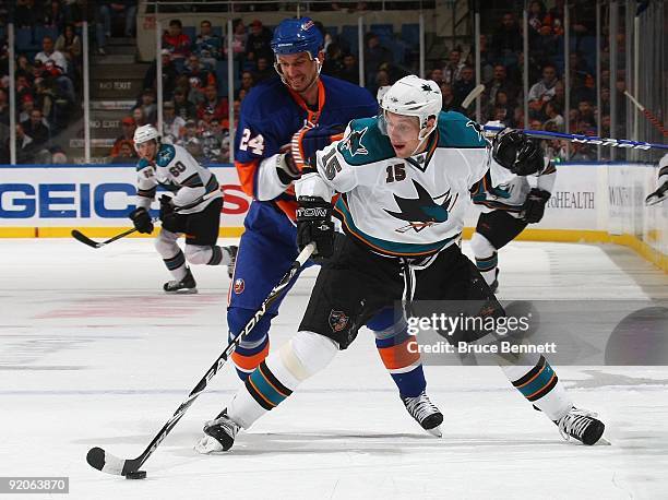 Radek Martinek of the New York Islanders skates against Dany Heatley of the San Jose Sharks at the Nassau Coliseum on October 17, 2009 in Uniondale,...