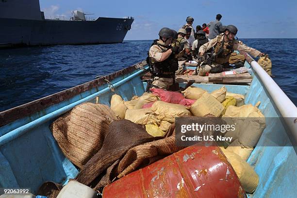 In this photo provided by the U.S. Navy, Members of a visit, board, search and seizure team from the guided-missile cruiser USS Anzio and U.S. Coast...