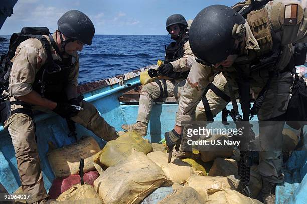 In this photo provided by the U.S. Navy, Members of a visit, board, search and seizure team from the guided-missile cruiser USS Anzio and U.S. Coast...