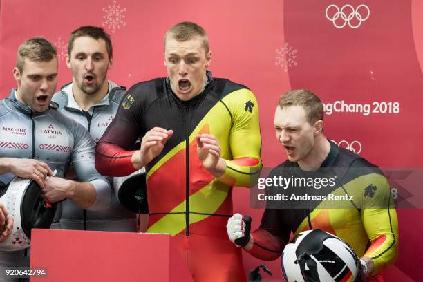 Thorsten Margis and Francesco Friedrich of Germany react as they watch the final run by Justin Kripps and Alexander Kopacz of Canada during the Men's...