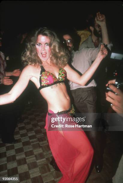 An unidentified party-goer dances in a bikini and transparent skirt at the nightclub Studio 54, New York, New York, late 1970s or early 1980s.