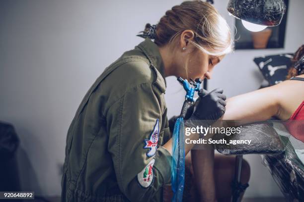 tattooing - tattooing stock pictures, royalty-free photos & images