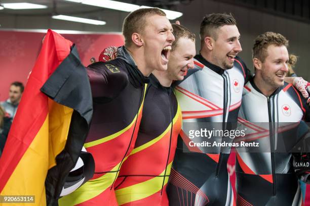 Joint gold medalists Thorsten Margis and Francesco Friedrich of Germany and Justin Kripps and Alexander Kopacz of Canada celebrate during the Men's...