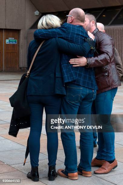 Abuse victims of former football coach Barry Bennell emrbace after speaking to the media outside Liverpool Crown Court on February 19, 2018 after the...