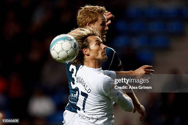 Sven Hannawald jumps for a header with Jonas Reckermann during the charity football match "Klitschko meets Becker" at the Carl-Benz stadium on...