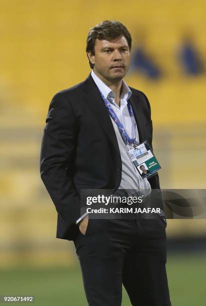 Tractor Sazi's coach Ertugrul Saglam watches from the sidelines during the AFC Champions League Group A football match between Qatar's Al-Gharafa and...