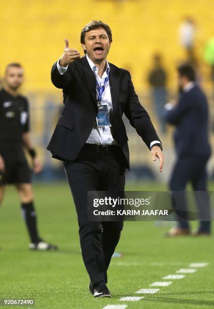 Tractor Sazi's coach Ertugrul Saglam reacts on the sidelines during the AFC Champions League Group A football match between Qatar's Al-Gharafa and...