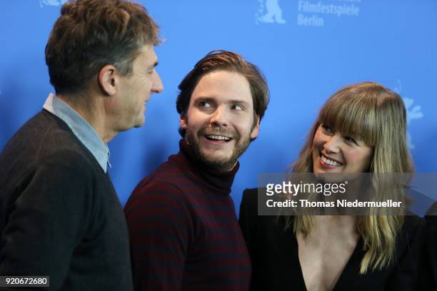 Tim Bevan, Daniel Bruehl and Rosamund Pike pose at the '7 Days in Entebbe' photo call during the 68th Berlinale International Film Festival Berlin at...
