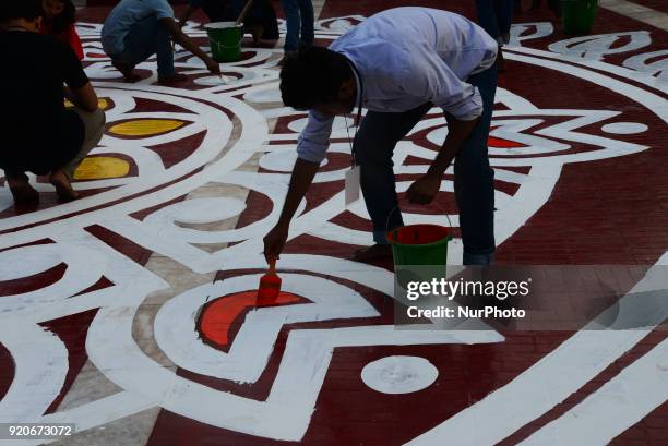 Bangladeshi fine arts students and teachers paints on the ground of the Central Shahid Minar , in Dhaka on February 19 as part of preparations for...