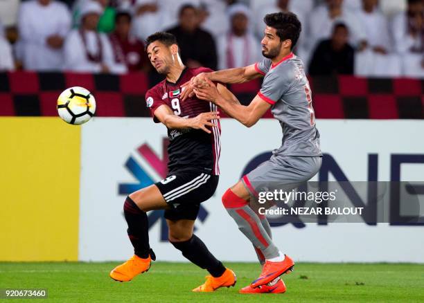 Al-Duhail's Karim Boudiaf vies for the ball against al-Wahda's Ismaeil Matar during their AFC Champions League round 2 group stage football match at...