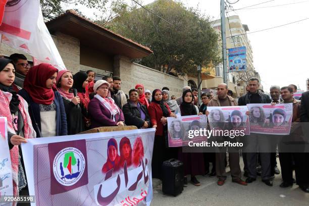 Palestinians hold poster of Ahed Tamimi during a protest to show solidarity with Palestinian prisoners held in Israeli jails, in front of Red cross...