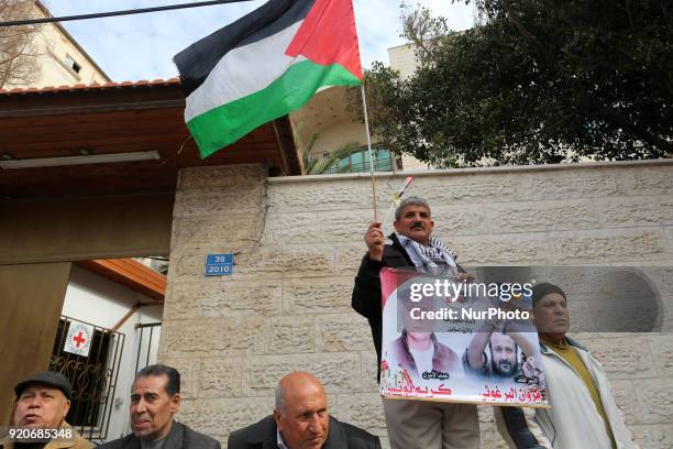 Palestinians hold poster of Ahed Tamimi during a protest to show solidarity with Palestinian prisoners held in Israeli jails, in front of Red cross...