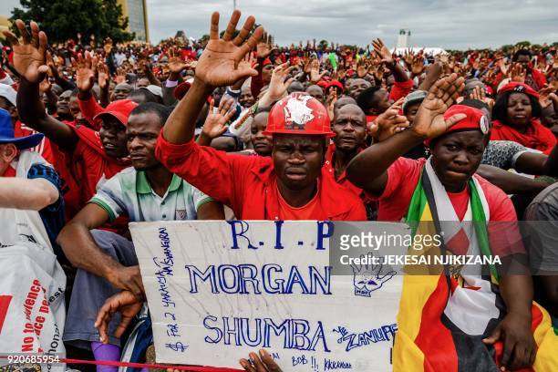 Man holds a placard reading "Rest In Peace" on February 19 during a gathering at Freedom Square in Harare of thousands of supporters of the Movement...