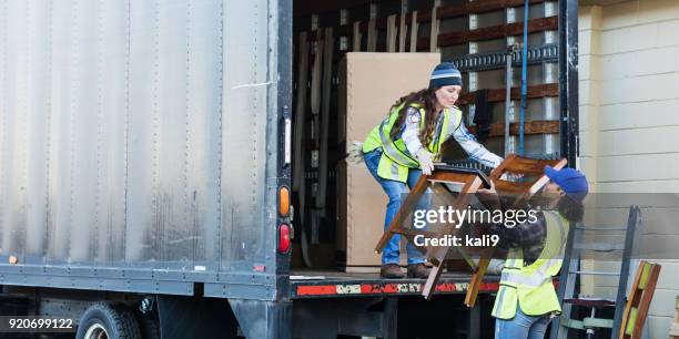 two female workers with a truck, moving furniture - unloading stock pictures, royalty-free photos & images