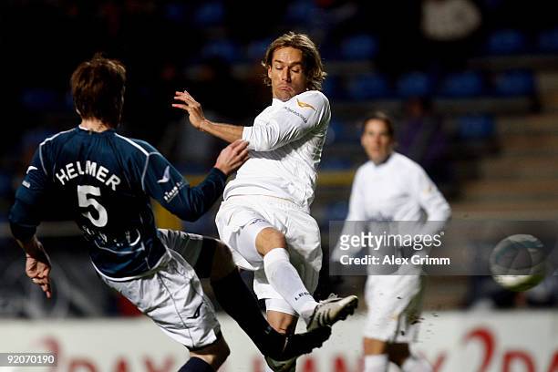 Sven Hannawald shoots the ball ahead of Thomas Helmer during the charity football match "Klitschko meets Becker" at the Carl-Benz stadium on October...