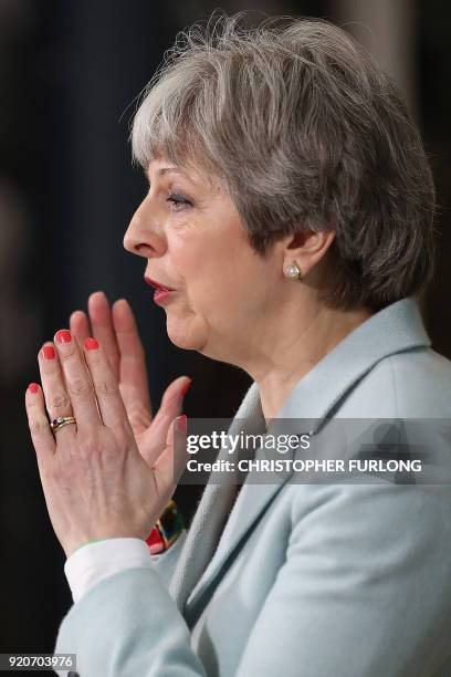 Britain's Prime Minister Theresa May delivers a speech on education at Derby College in Derby, northern England on February 19, 2018 to launch a...