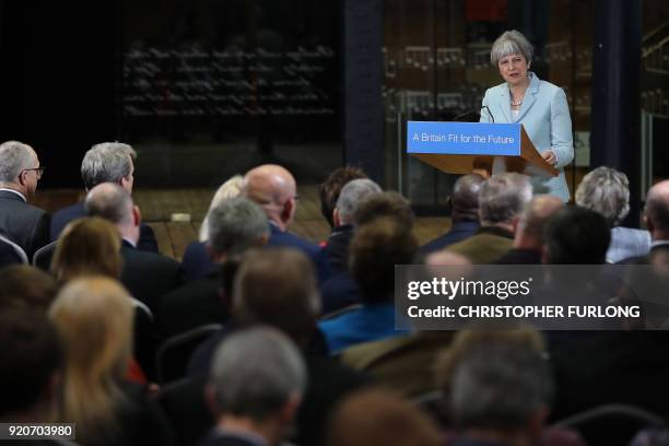 Britain's Prime Minister Theresa May delivers a speech on education at Derby College in Derby, northern England on February 19, 2018 to launch a...