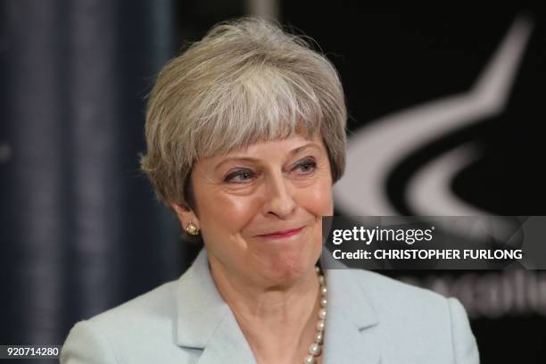 Britain's Prime Minister Theresa May delivers a speech on education at Derby College in Derby, northern England on February 19, 2018 to launch a...