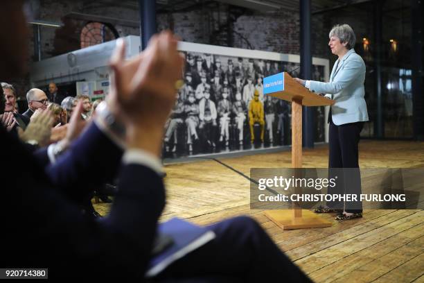 Britain's Prime Minister Theresa May receives applause as she delivers a speech on education at Derby College in Derby, northern England on February...