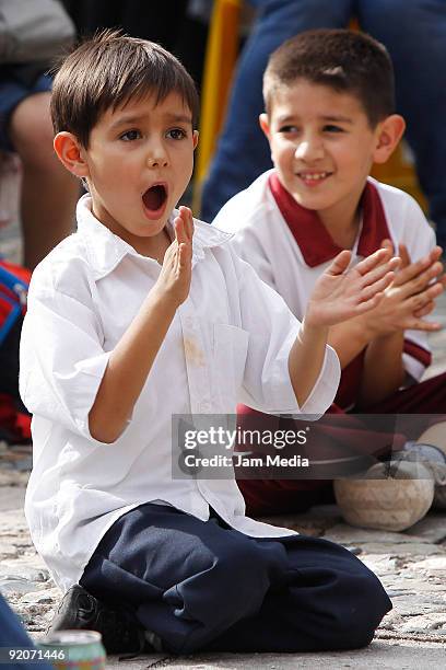 Child observes as artists of the Spanish Street Circus 'Cruzando el Charco' perform during the Cervantino International Festival 2009 on October 19,...