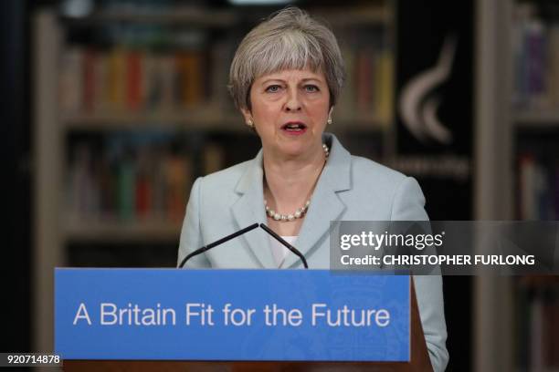 Britain's Prime Minister Theresa May delivers a speech on education at Derby College in Derby, northern England on February 19, 2018 to launch a...