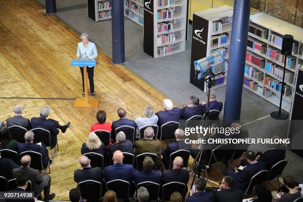 Britain's Prime Minister Theresa May delivers a speech on education at Derby College in Derby, northern England on February 19, 2018 to launch a...