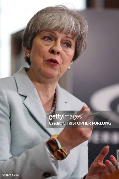 Britain's Prime Minister Theresa May delivers a speech on education at Derby College in Derby, northern England on February 19, 2018 to launch a...