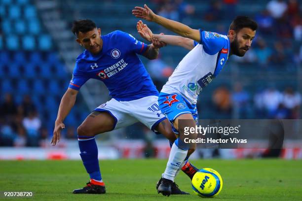 Walter Montoya of Cruz Azul struggles for the ball with Jose Guerrero of Puebla during the 8th round match between Cruz Azul and Puebla as part of...