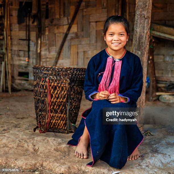 laotian little girl carrying a basket in a village in northern laos - akha woman stock pictures, royalty-free photos & images