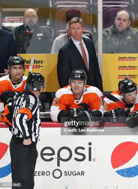 Head Coach Dave Hakstol of the Philadelphia Flyers looks toward Referee Kyle Rehman behind Valtteri Filppula, Jori Lehtera and Jordan Weal against...