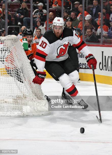 Jimmy Hayes of the New Jersey Devils skates after the loose puck against Andrew MacDonald of the Philadelphia Flyers on February 13, 2018 at the...