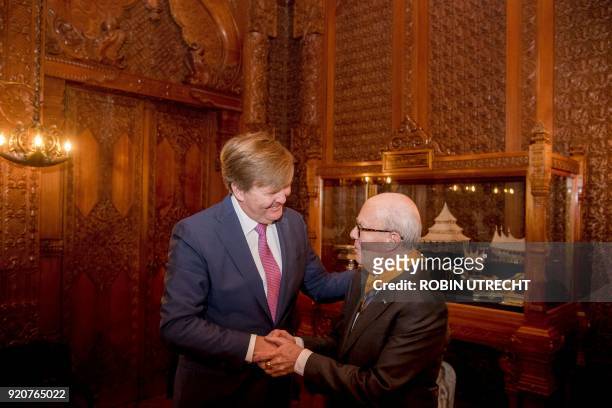 Dutch choreographer Hans van Manen shakes hands with Dutch king Willem-Alexander, after he received a honorary medal of Art and Science of the Order...