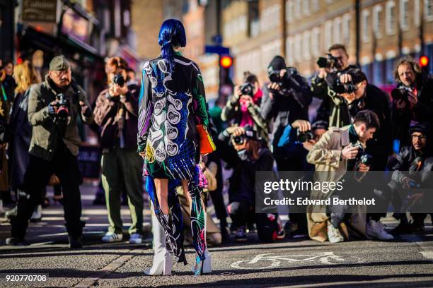 Guest is posing in front of street style photographers , during London Fashion Week February 2018 on February 17, 2018 in London, England.