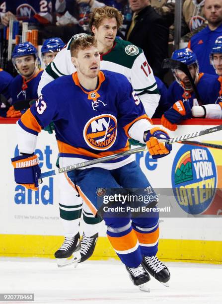 Casey Cizikas of the New York Islanders and Marcus Foligno of the Minnesota Wild both lose their helmets after a tussle during the first period at...