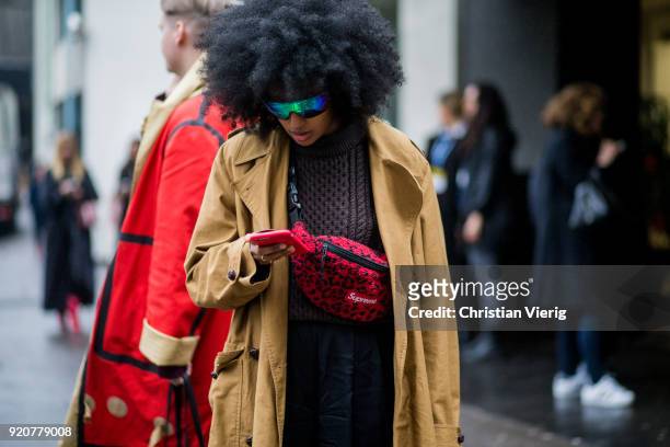 Julia Sarr-Jamois wearing Supreme fanny bag, trench coat seen outside Marques Almeida during London Fashion Week February 2018 on February 19, 2018...