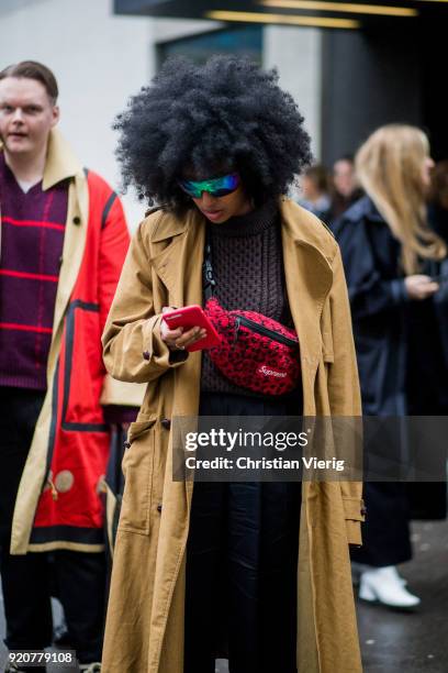 Julia Sarr-Jamois wearing Supreme fanny bag, trench coat seen outside Marques Almeida during London Fashion Week February 2018 on February 19, 2018...