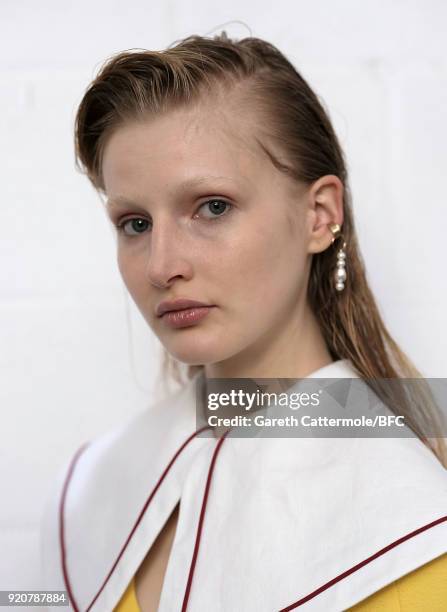 Model backstage ahead of the Emilia Wickstead show during London Fashion Week February 2018 at Great Portland Street on February 19, 2018 in London,...