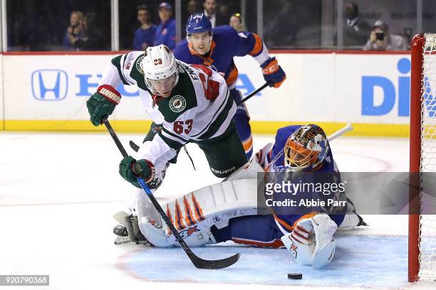 Tyler Ennis of the Minnesota Wild takes a shot against Jaroslav Halak of the New York Islanders in the first period during their game at Barclays...