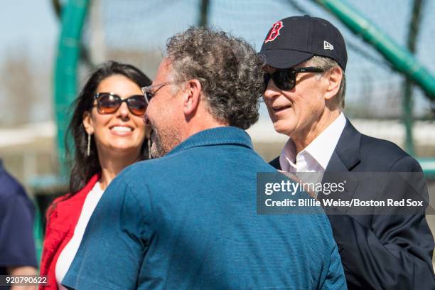 Principal Owner John Henry and his wife Linda Pizzuti Henry, and President & CEO Sam Kennedy of the Boston Red Sox talk during a team workout on...