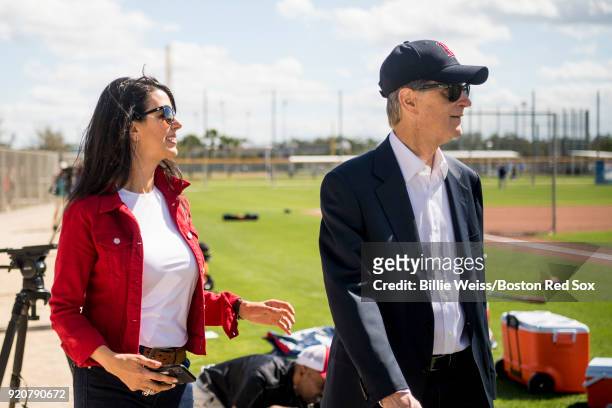 Principal Owner John Henry of the Boston Red Sox and his wife Linda Pizzuti Henry walk on the field during a team workout on February 19, 2018 at...