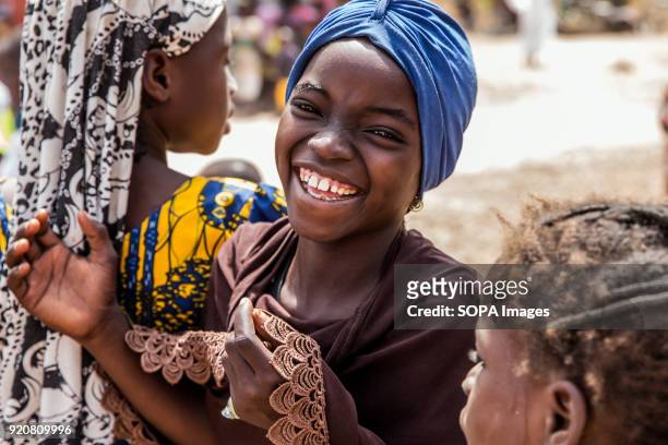 Young girl poses for a photo at TimTooni Football Club, just outside Tamale in Northern Ghana. Along with football coaches from London, time was...
