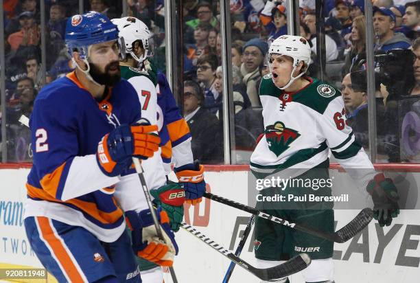 Tyler Ennis of the Minnesota Wild celebrates his second-period goal as Nick Leddy of the New York Islanders reacts at Barclays Center on February 19,...