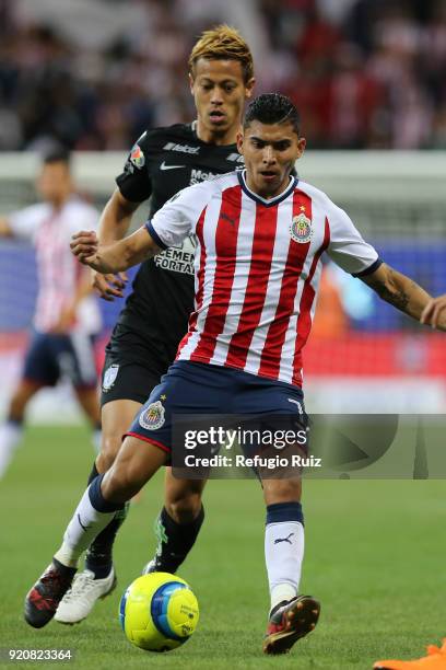 Orbelin Pineda of Chivas fights for the ball with Keisuke Honda of Pachuca during on the 8th round match between Chivas and Pachuca as part of the...