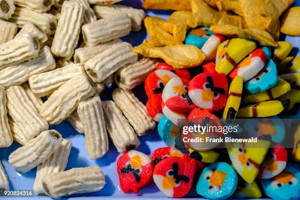 Colorful food pieces made from fish powder are displayed to get fried at a street restaurant.