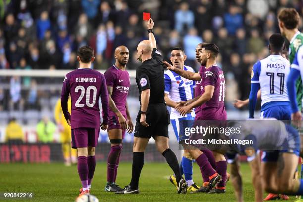 Fabian Delph of Manchester City is shown a red card by referee Anthony Taylor during the Emirates FA Cup Fifth Round match between Wigan Athletic and...