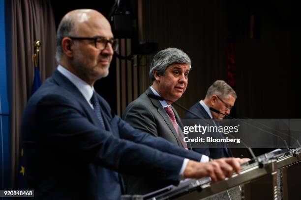 Mario Centeno, Portugal's finance minister and head of the group of euro-area finance ministers, center, speaks during a news conference with Pierre...