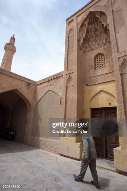 Man walking outside the Nain Grand Mosque or 'Masjed-e Jame' Nain' in Persian, is a congregation mosque and one of Iran's oldest. It originally dates...