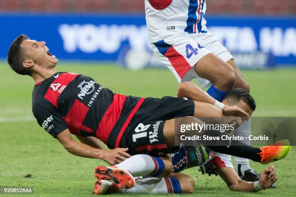 Christopher Ikonomidis of the Wanderers is heavily tackled by Jets Daniel Georgievski during the round one A-League match between the Western Sydney...