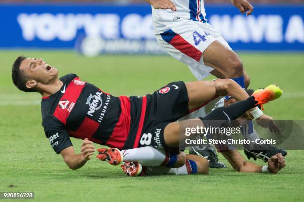 Christopher Ikonomidis of the Wanderers is heavily tackled by Jets Daniel Georgievski during the round one A-League match between the Western Sydney...