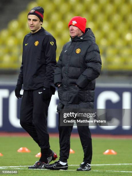 Sir Alex Ferguson and Dimitar Berbatov of Manchester United in action during a training session ahead of their UEFA Champions League match against...
